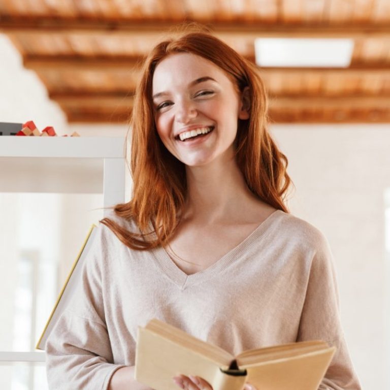 happy-redhead-young-lady-student-reading-book-M5Z7RVC@2x-1-768x735